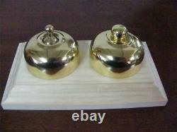 Polished brass light switch and dimmer on pine wooden block